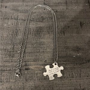 Necklace that is sterling silver chain and piece.